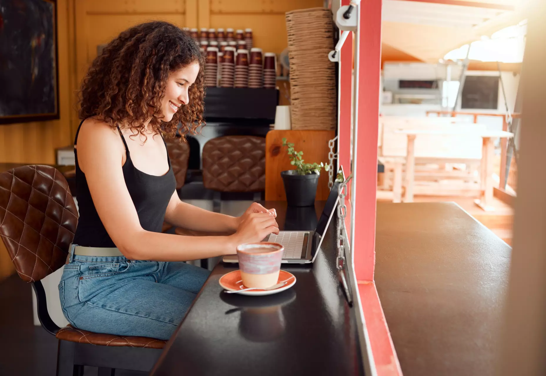 SEO expert working in a cafe. What Is One of the Disadvantages of Hub and Spoke Topology in Regards to SEO?